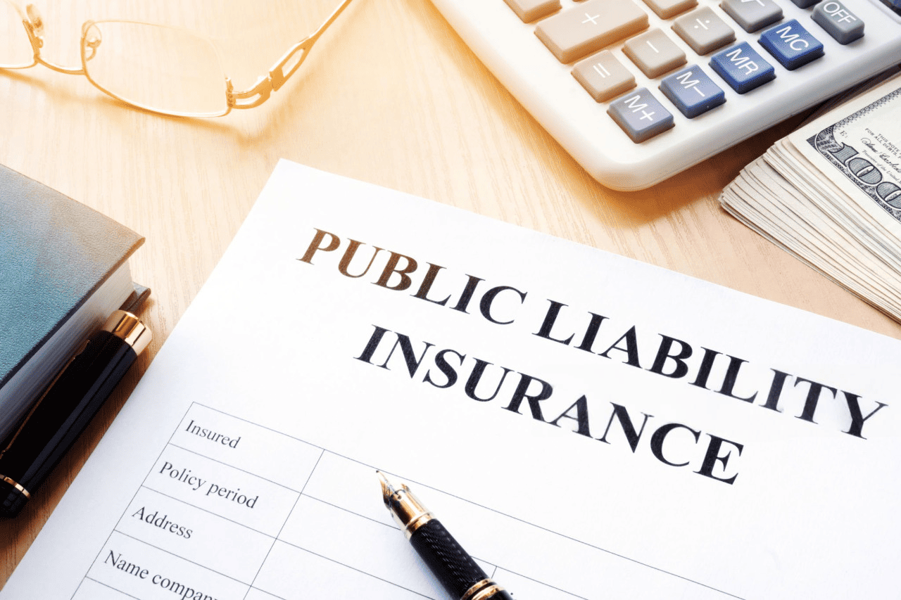Paperwork and tools required for a Public Liability Claim, including an insurance form, pen, calculator, and reading glasses